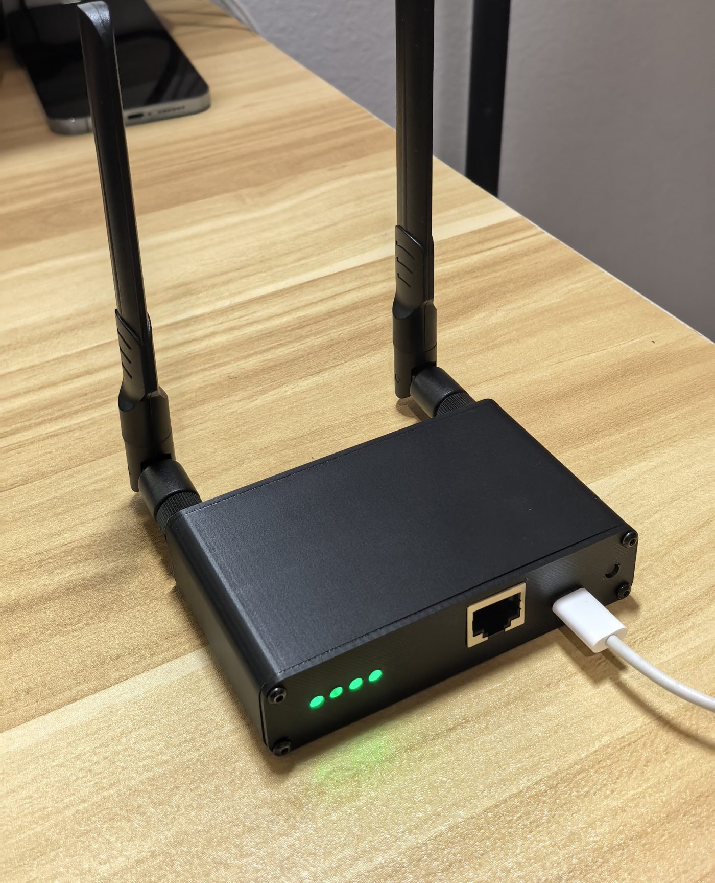 bitEngine Hub prototype with two antennas, four green status LEDs, an Ethernet port and USB-C power